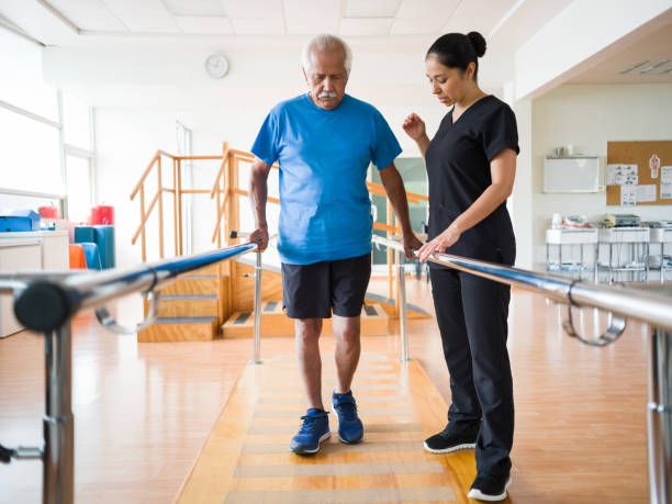 Expert caregiver helping an elderly man
